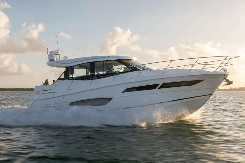 Yacht Photos Pics Manufacturer Provided Image: 2020 Regal 38 Grande Coupe cruising on water at sunset.