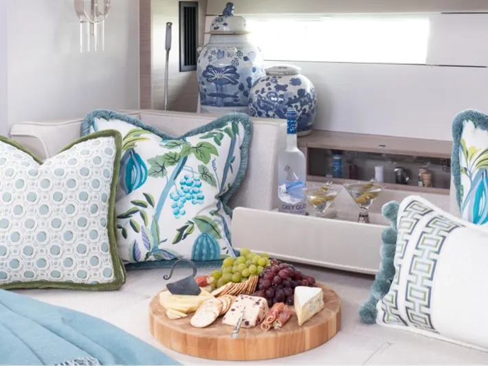 Navigamus Yacht Photos Pics Luxurious interior of 2023 Hanse 460 yacht with elegant decor and gourmet platter.