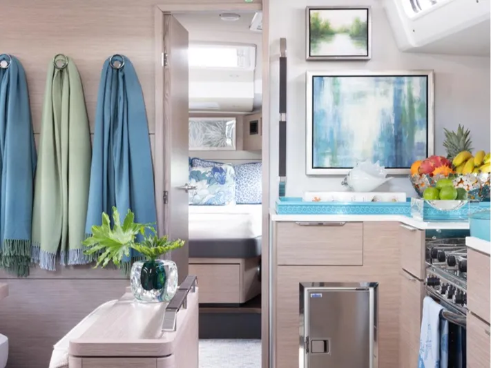 Navigamus Yacht Photos Pics Modern interior of 2023 Hanse 460 yacht with stylish decor and kitchen amenities.