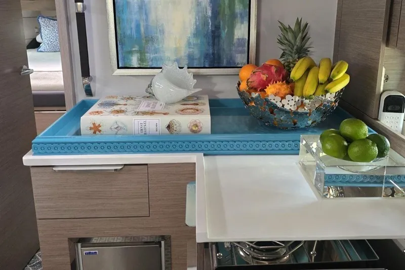 Navigamus Yacht Photos Pics Modern kitchen interior on 2023 Hanse 460 yacht with fruit bowl and decorative elements.