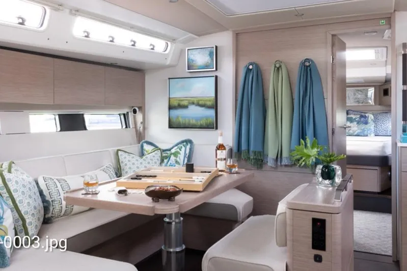 Navigamus Yacht Photos Pics Luxurious interior of 2023 Hanse 460 yacht with elegant dining area and modern decor.