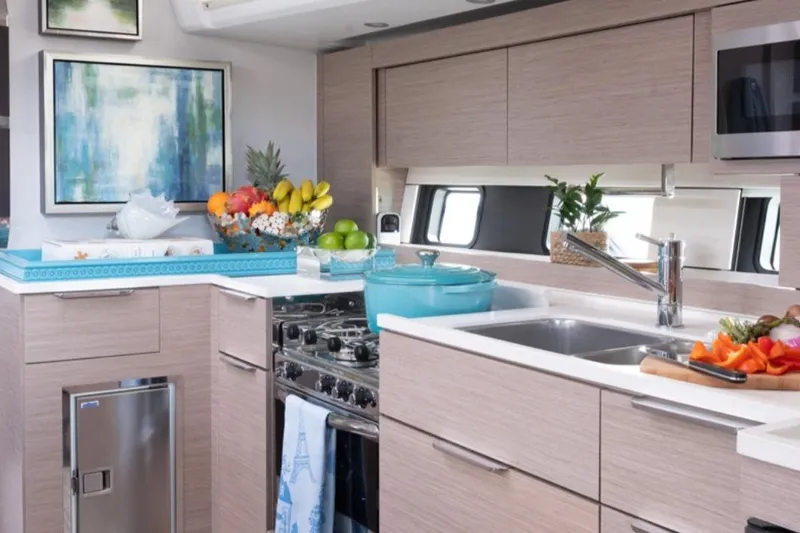 Navigamus Yacht Photos Pics Modern kitchen interior on 2023 Hanse 460 yacht with sleek cabinetry and vibrant decor.
