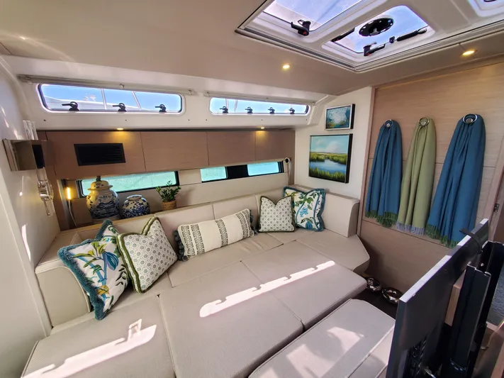 Navigamus Yacht Photos Pics Luxurious interior of 2023 Hanse 460 yacht with elegant seating and decorative pillows.