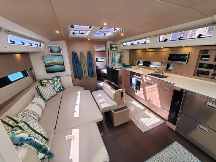 Navigamus Yacht Photos Pics Luxurious interior of 2023 Hanse 460 yacht with modern kitchen and cozy seating area.