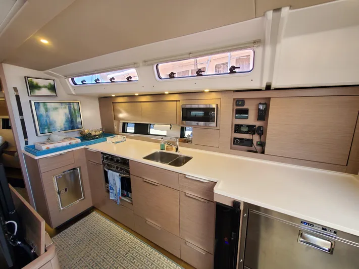 Navigamus Yacht Photos Pics Modern kitchen interior of 2023 Hanse 460 yacht with sleek cabinetry and appliances.