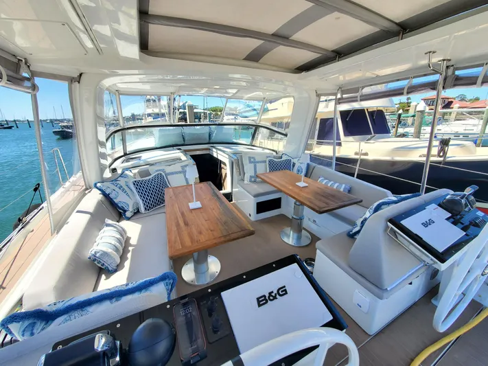 Navigamus Yacht Photos Pics Luxurious 2023 Hanse 460 yacht interior with elegant seating and wooden tables.