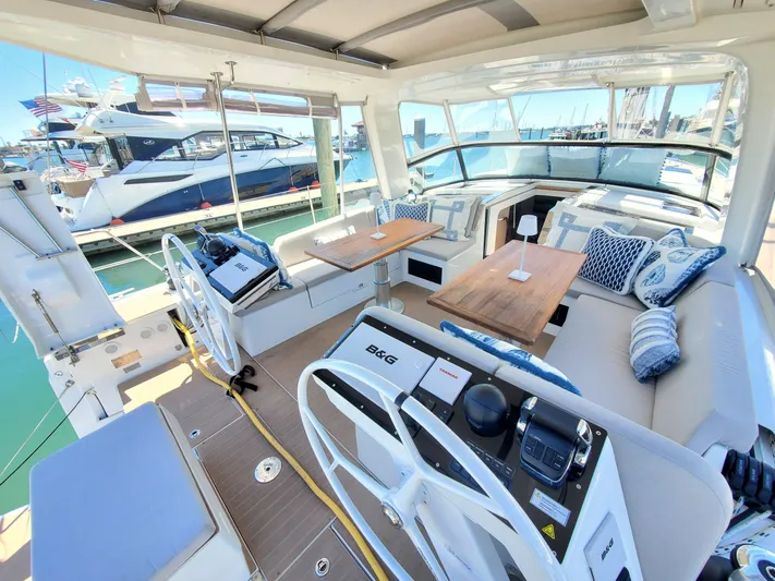 Navigamus Yacht Photos Pics Luxurious 2023 Hanse 460 yacht interior with dual steering wheels and elegant seating area.
