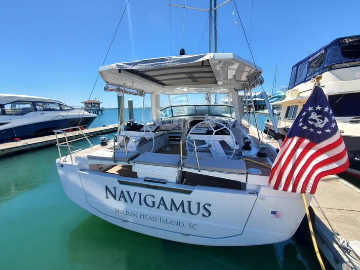 Navigamus Yacht Photos Pics 2023 Hanse 460 yacht docked, displaying American flag, clear blue sky background.