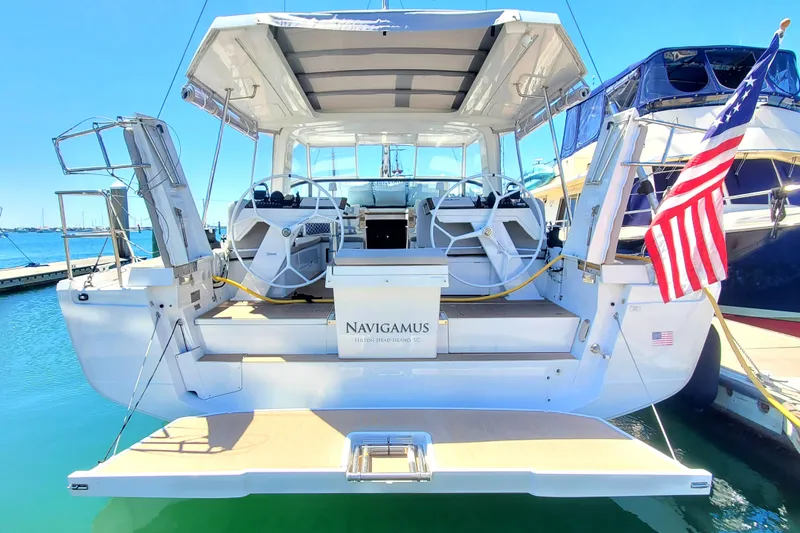 Navigamus Yacht Photos Pics 2023 Hanse 460 yacht with open deck, docked at marina, featuring American flag.