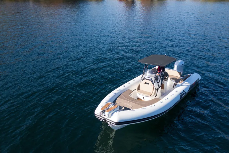  Yacht Photos Pics 2026 BWA GTO 308 boat on calm blue water, featuring sleek design and canopy.