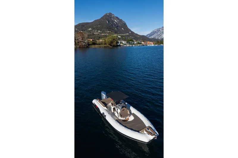  Yacht Photos Pics BWA GTO 308 boat on a serene lake with mountain backdrop, 2026 model.