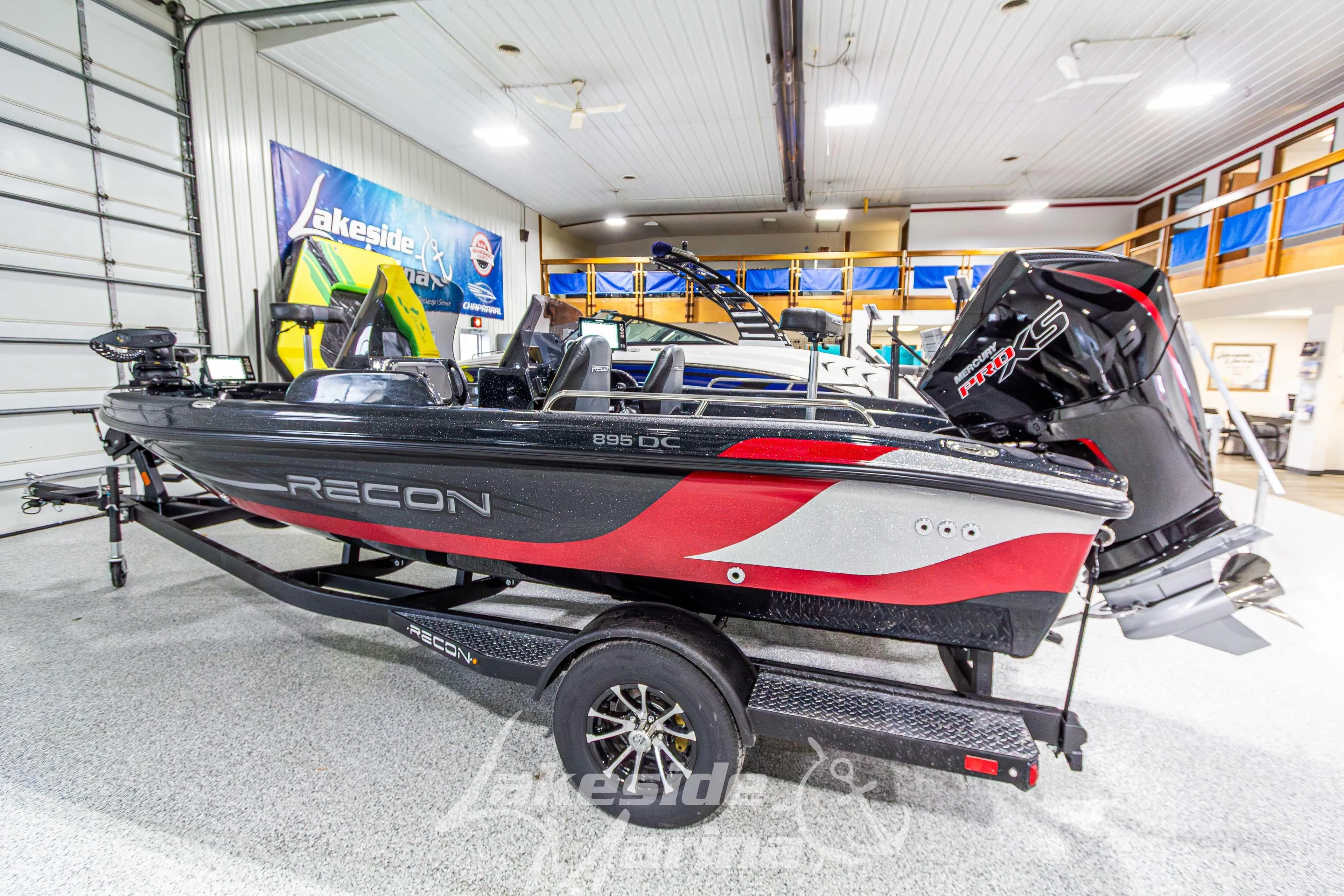 2026 Recon 895 DC boat in showroom, featuring sleek design and powerful engine.