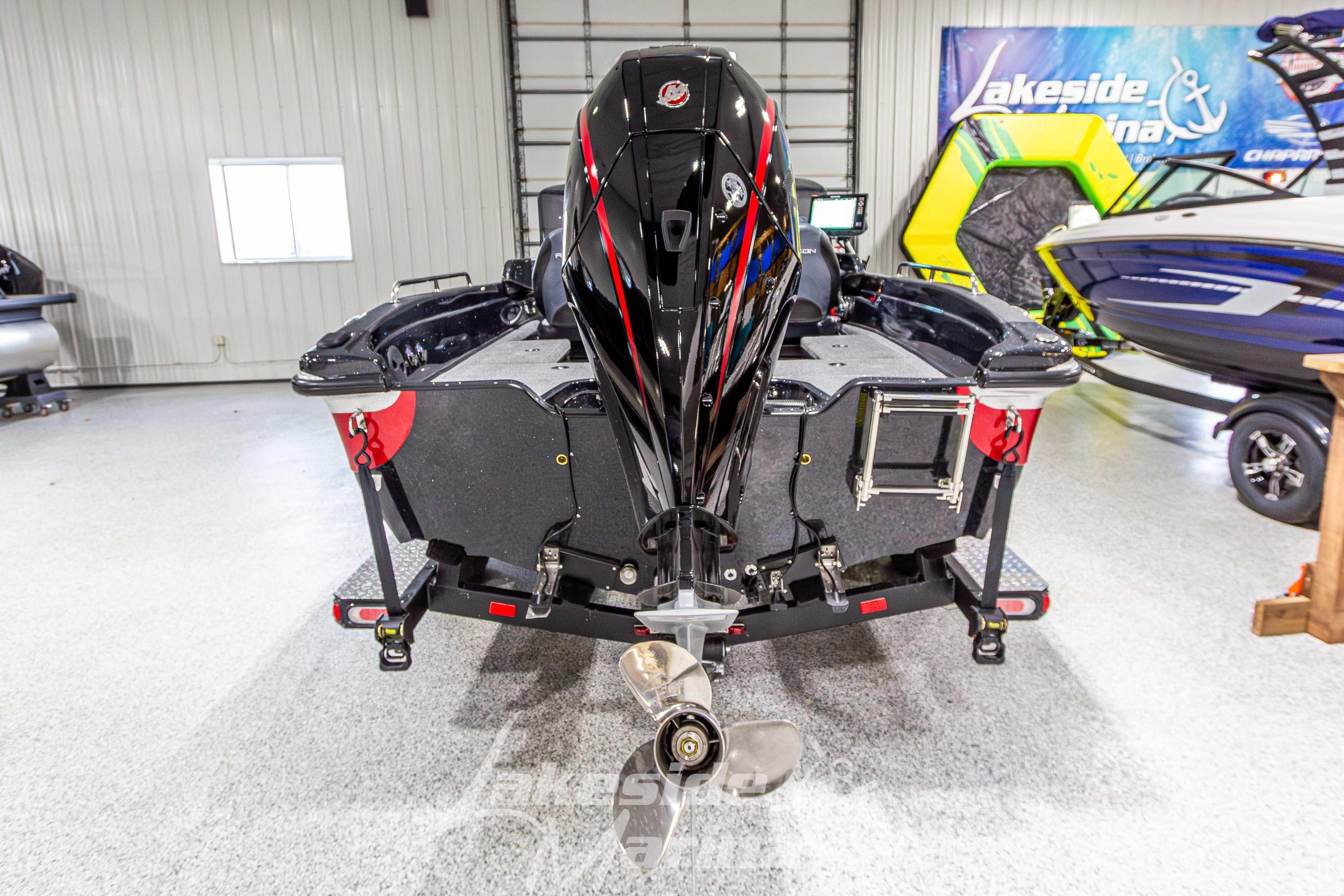 2026 Recon 895 DC boat in showroom, rear view with outboard motor.