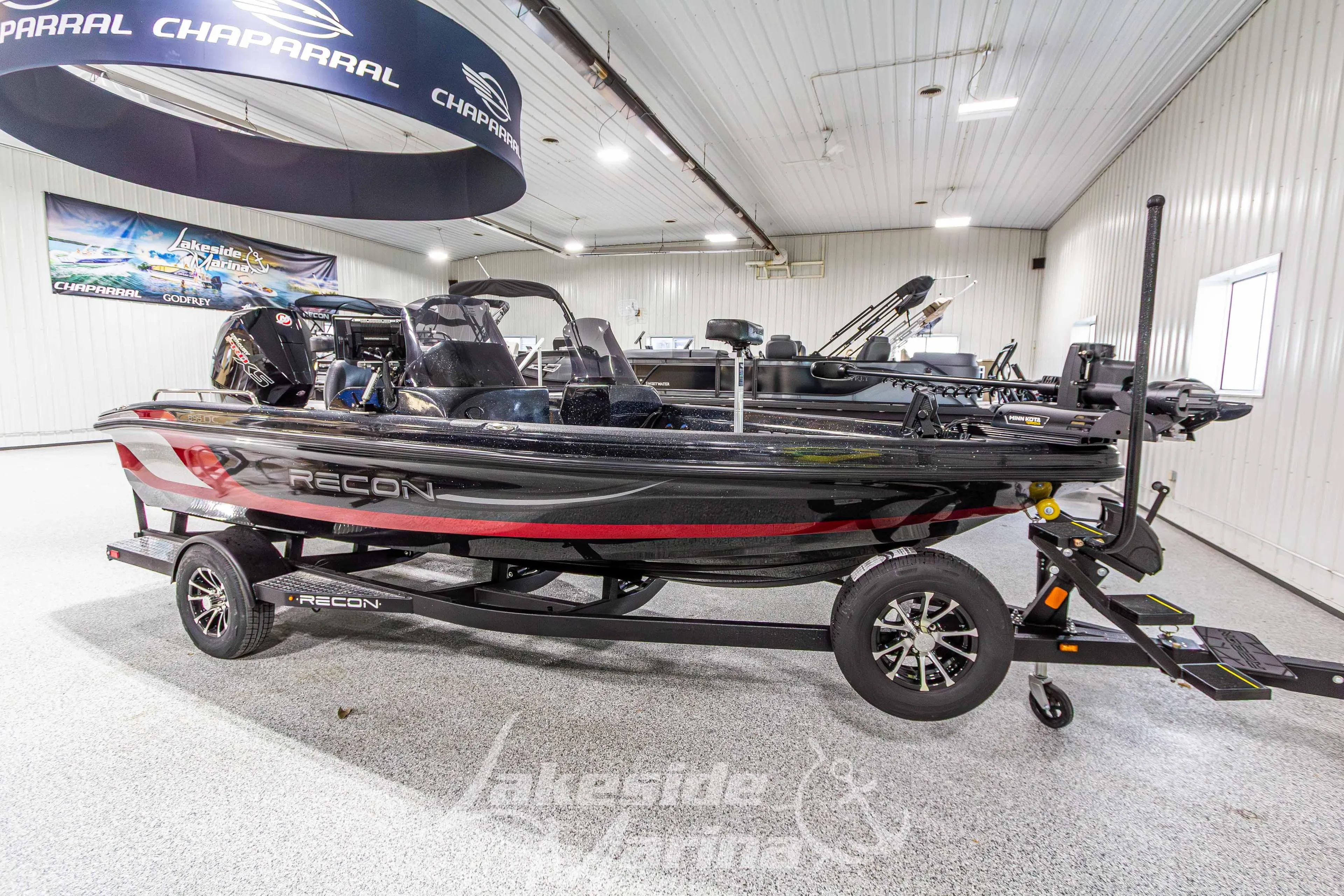 2026 Recon 895 DC boat displayed indoors on a trailer.