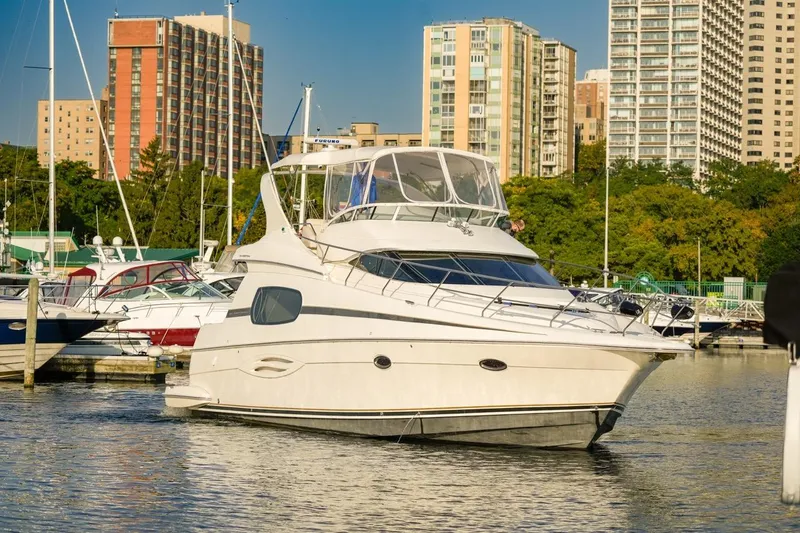  Yacht Photos Pics 2003 Silverton 410 Sport Bridge yacht docked in urban marina setting.