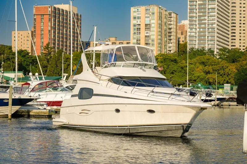  Yacht Photos Pics 2003 Silverton 410 Sport Bridge yacht docked in urban marina setting.