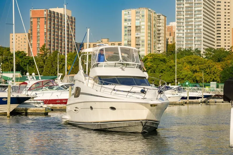  Yacht Photos Pics 2003 Silverton 410 Sport Bridge yacht docked in urban marina setting.