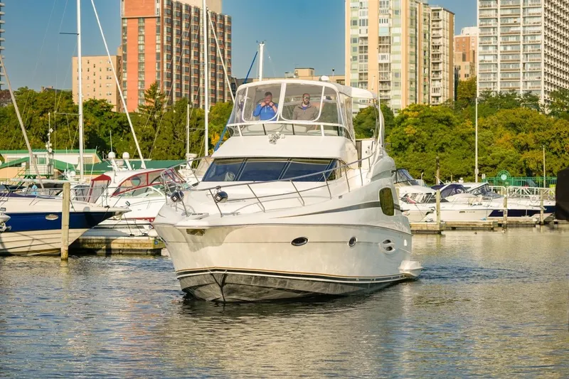  Yacht Photos Pics 2003 Silverton 410 Sport Bridge yacht docked in urban marina setting.