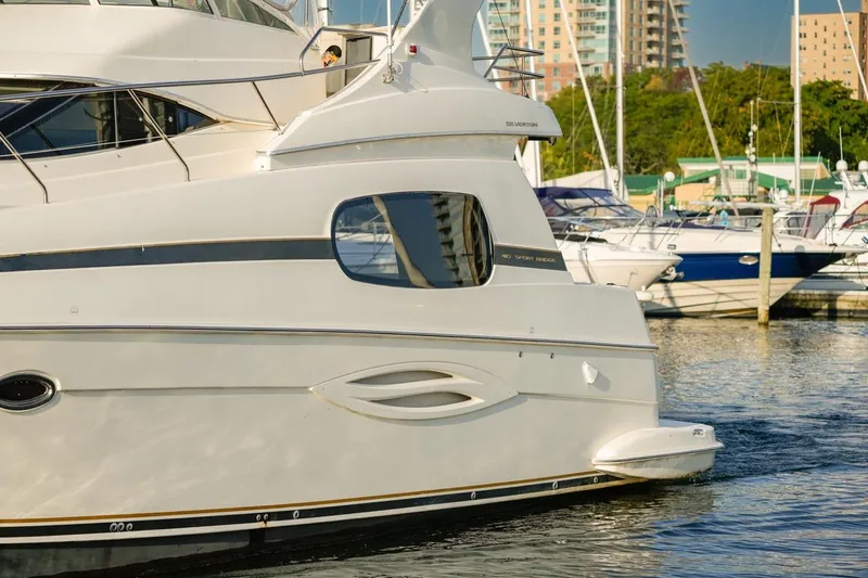  Yacht Photos Pics 2003 Silverton 410 Sport Bridge yacht docked at marina with cityscape background.