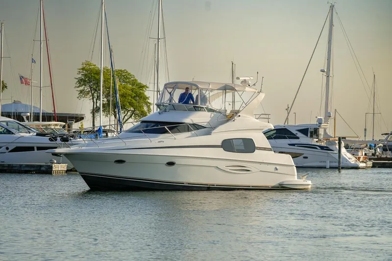  Yacht Photos Pics 2003 Silverton 410 Sport Bridge yacht docked in a marina with sailboats.
