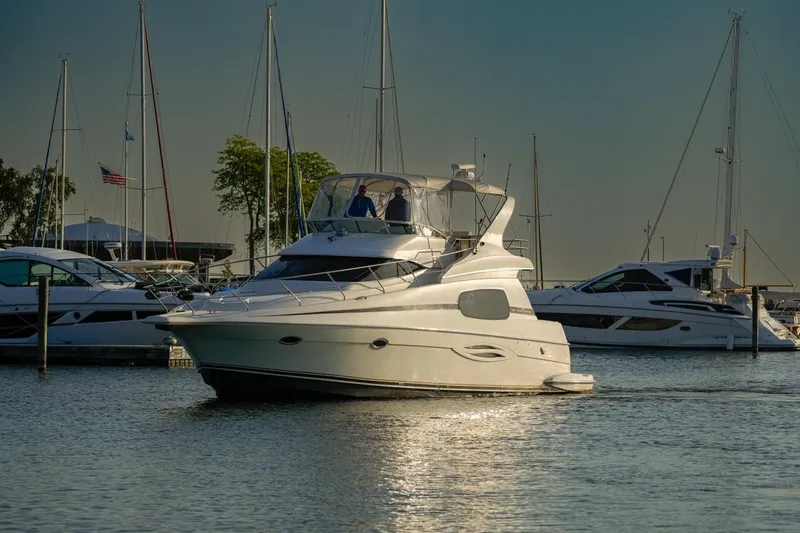  Yacht Photos Pics 2003 Silverton 410 Sport Bridge yacht in marina, surrounded by other boats.