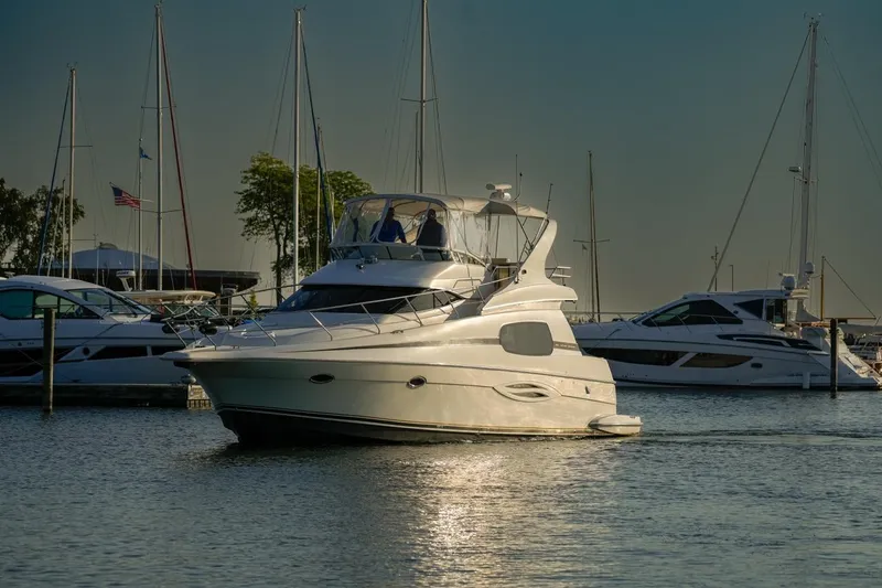  Yacht Photos Pics 2003 Silverton 410 Sport Bridge yacht docked in a marina with other boats.