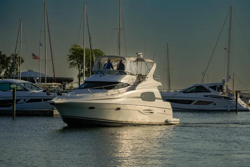  Yacht Photos Pics 2003 Silverton 410 Sport Bridge yacht docked in a marina, surrounded by other boats.