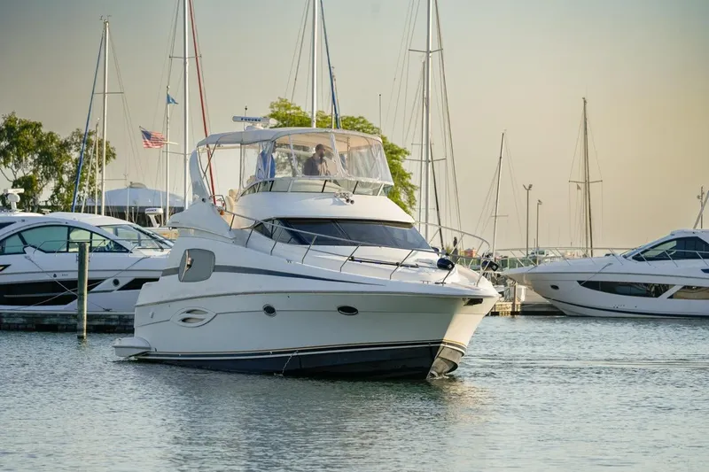  Yacht Photos Pics 2003 Silverton 410 Sport Bridge yacht docked in a marina, surrounded by other boats.