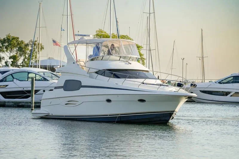  Yacht Photos Pics 2003 Silverton 410 Sport Bridge yacht docked in a marina, surrounded by other boats.