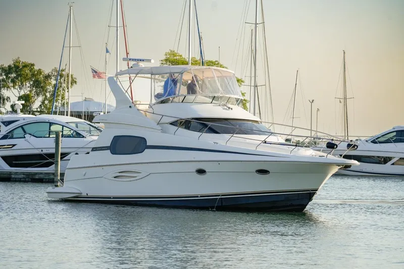  Yacht Photos Pics 2003 Silverton 410 Sport Bridge yacht docked in a marina, surrounded by other boats.