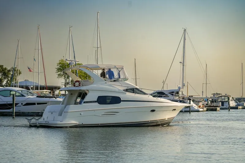  Yacht Photos Pics 2003 Silverton 410 Sport Bridge yacht docked in a marina at sunset.
