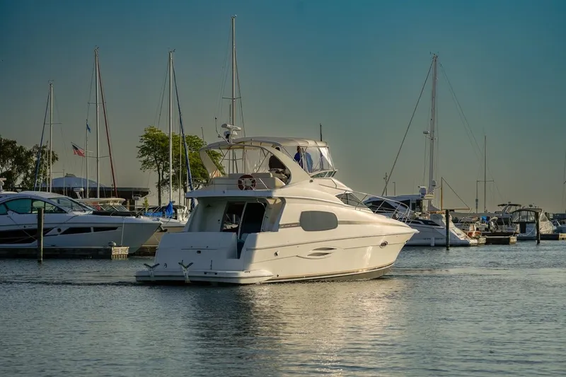  Yacht Photos Pics 2003 Silverton 410 Sport Bridge yacht docked in a marina under clear skies.