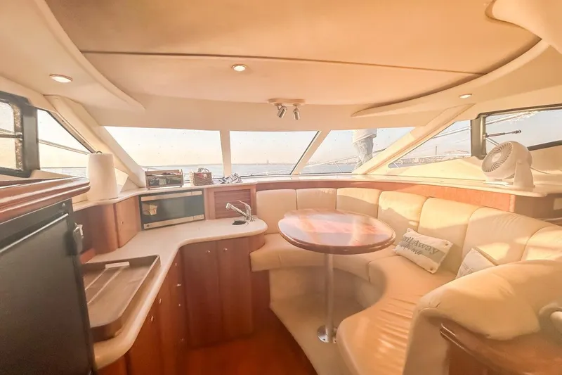  Yacht Photos Pics Luxurious interior of 2003 Silverton 410 Sport Bridge yacht with cozy seating and dining area.