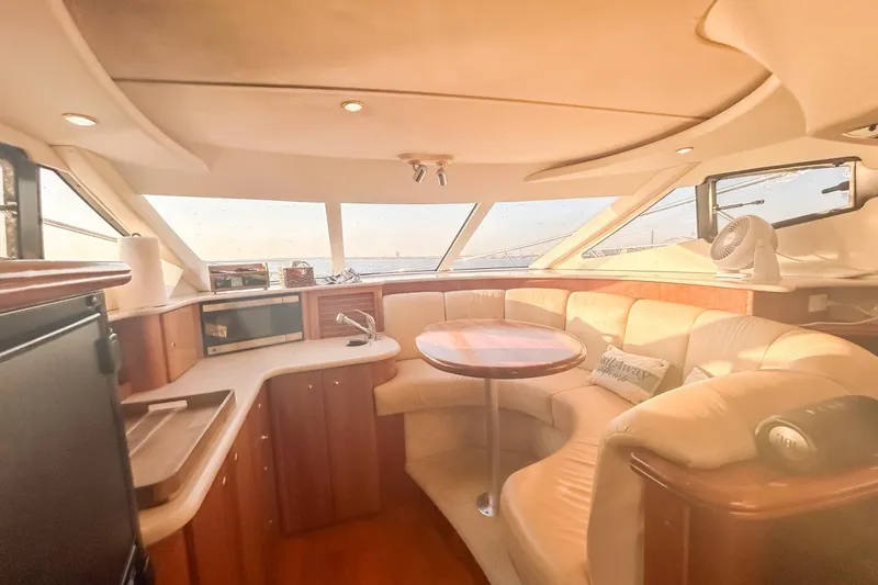  Yacht Photos Pics Luxurious interior of 2003 Silverton 410 Sport Bridge yacht with plush seating and modern amenities.