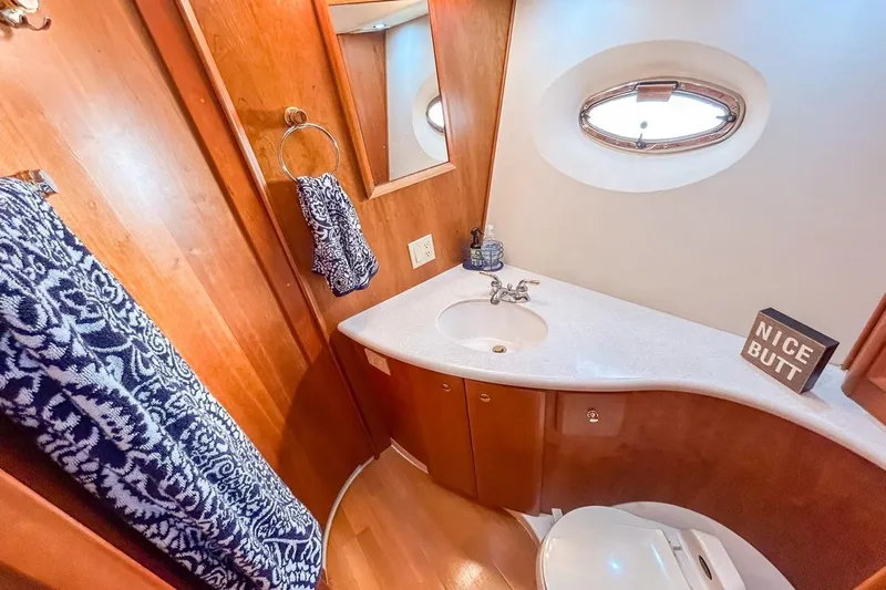  Yacht Photos Pics Luxurious 2003 Silverton 410 Sport Bridge bathroom with wood accents and nautical decor.