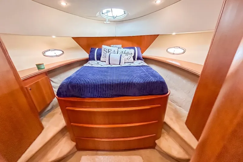  Yacht Photos Pics Luxurious cabin interior of 2003 Silverton 410 Sport Bridge yacht with cozy bedding.
