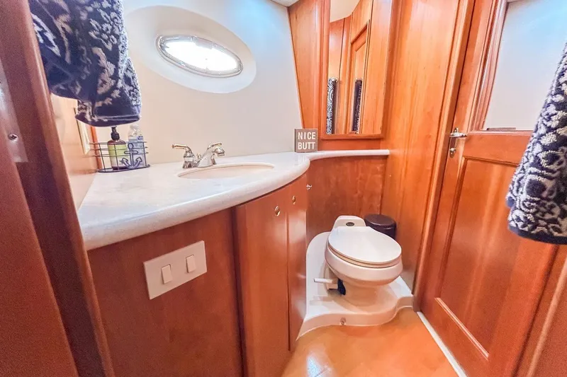  Yacht Photos Pics Bathroom interior of 2003 Silverton 410 Sport Bridge yacht with wooden cabinetry.