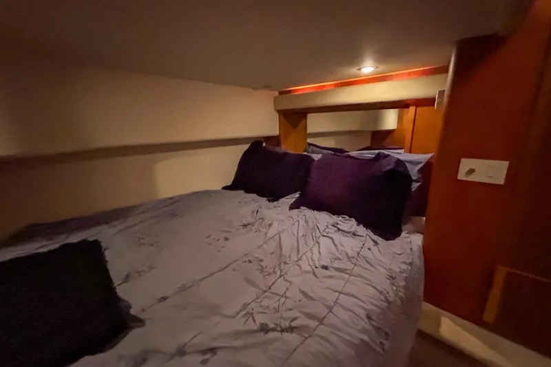 Yacht Photos Pics Cozy bedroom interior of 2003 Silverton 410 Sport Bridge yacht with plush bedding.