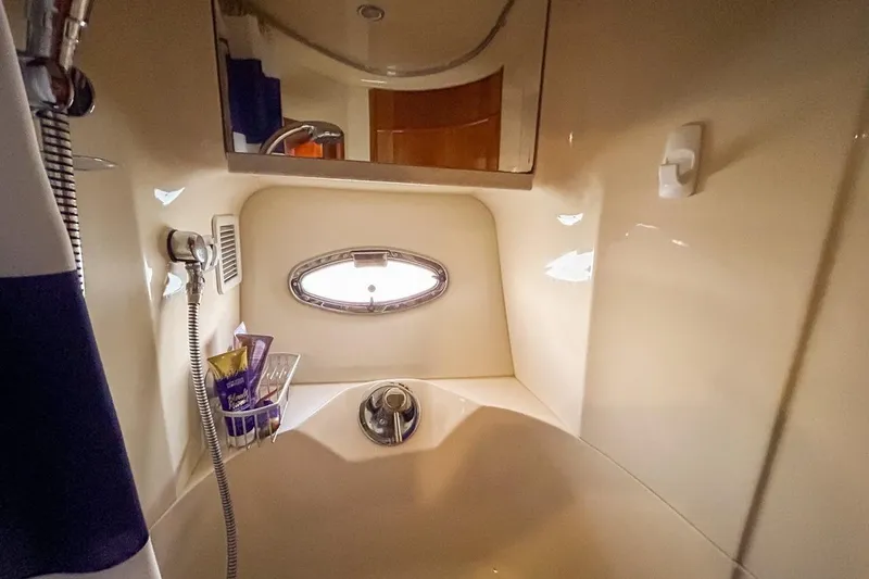  Yacht Photos Pics Bathroom interior of 2003 Silverton 410 Sport Bridge yacht with shower and porthole.