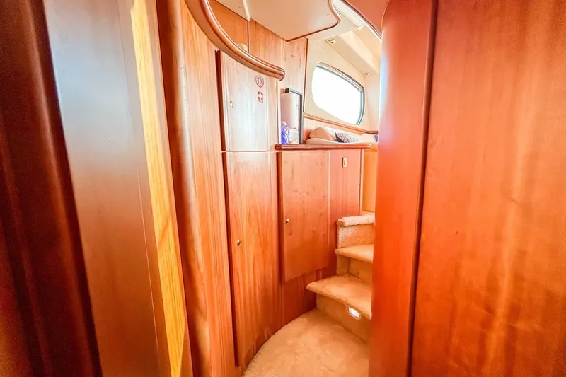  Yacht Photos Pics Interior of 2003 Silverton 410 Sport Bridge with wooden cabinetry and carpeted stairs.