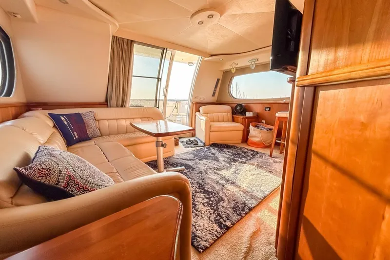  Yacht Photos Pics Luxurious interior of a 2003 Silverton 410 Sport Bridge yacht with plush seating and elegant decor.