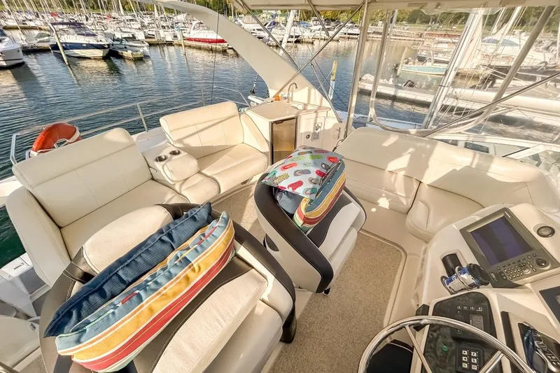 Yacht Photos Pics Luxurious 2003 Silverton 410 Sport Bridge yacht interior with plush seating and marina view.