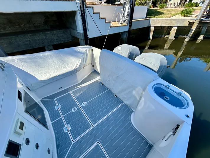 All Gas No Brakes Yacht Photos Pics 2020 Regal 33 SAV boat deck with covered engines and sleek flooring.