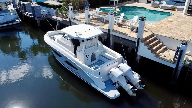 All Gas No Brakes Yacht Photos Pics 2020 Regal 33 SAV boat docked by a poolside marina.