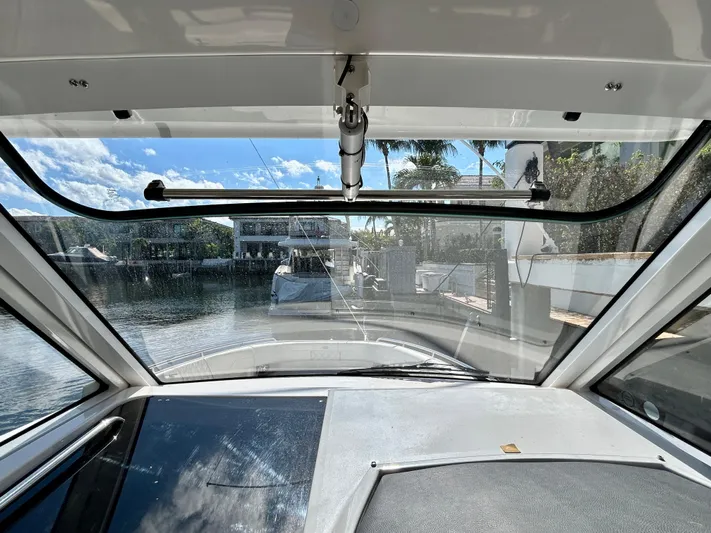 All Gas No Brakes Yacht Photos Pics View from inside a 2020 Regal 33 SAV boat, overlooking a marina.