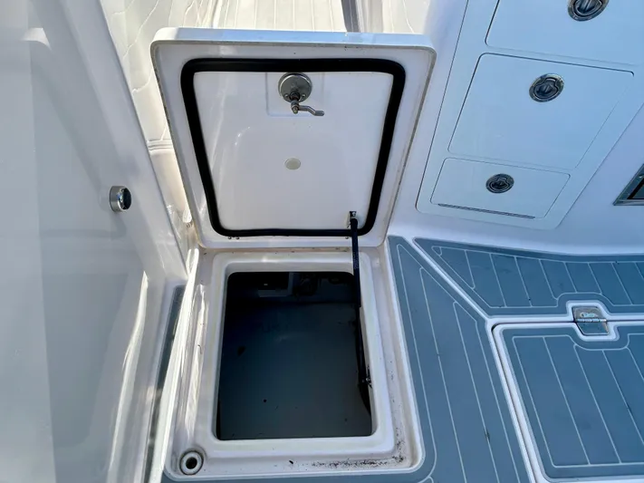 All Gas No Brakes Yacht Photos Pics Open storage compartment on 2020 Regal 33 SAV boat deck.