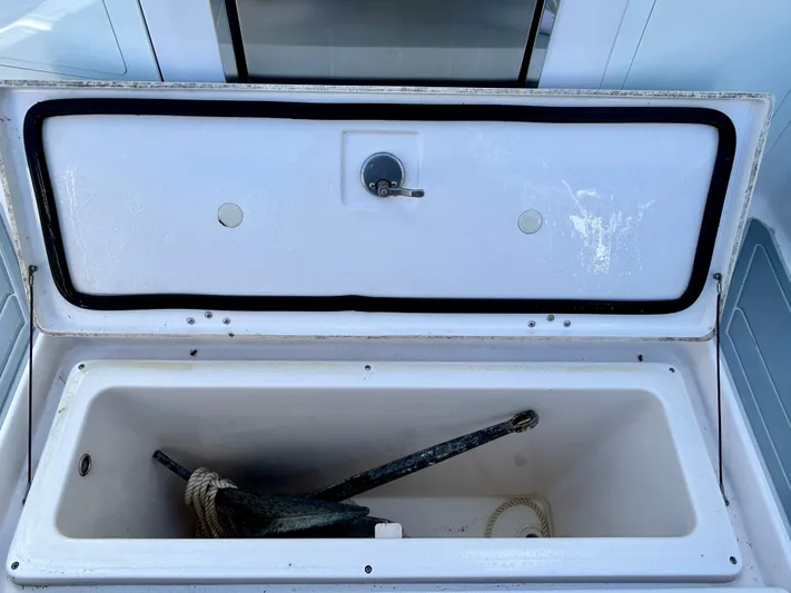 All Gas No Brakes Yacht Photos Pics Open storage compartment on 2020 Regal 33 SAV boat with anchor and rope inside.