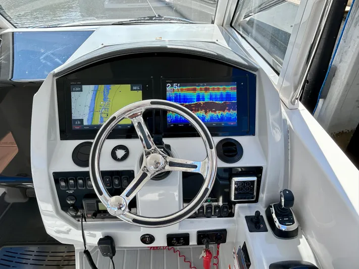 All Gas No Brakes Yacht Photos Pics 2020 Regal 33 SAV boat dashboard with navigation screens and steering wheel.