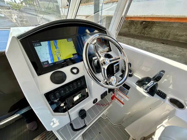 All Gas No Brakes Yacht Photos Pics 2020 Regal 33 SAV boat helm with navigation display and steering wheel.