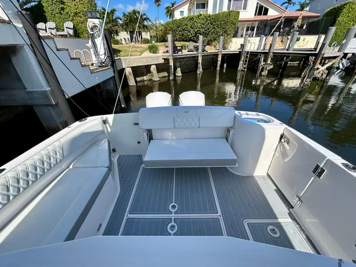 All Gas No Brakes Yacht Photos Pics 2020 Regal 33 SAV boat interior with seating, docked by waterfront homes.